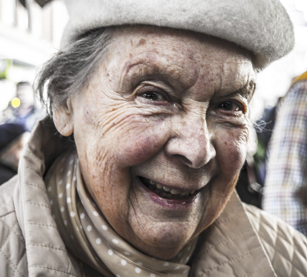 Old woman looking closely to the camera.