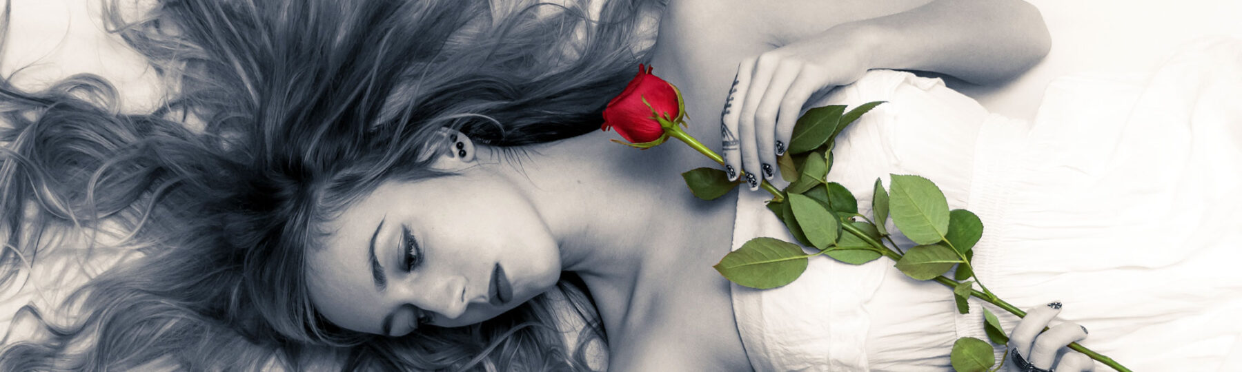 lady in black & white with a red rose looking down